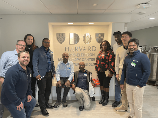 Photo of participants from first workshop clustered around sign for CryoEM Center